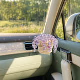 Purple beaded plant car charm sparkling in sunlight