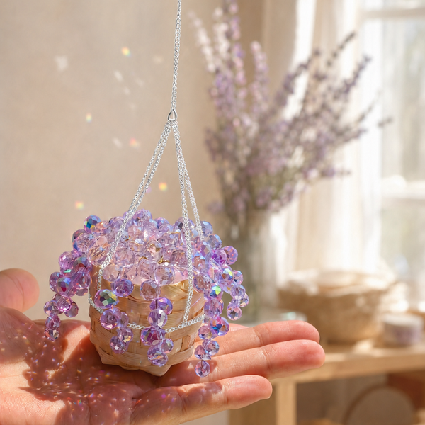 Hand holding mini purple beaded plant with bright silver chain
