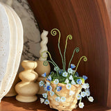 Blue and white beaded flowers in woven basket