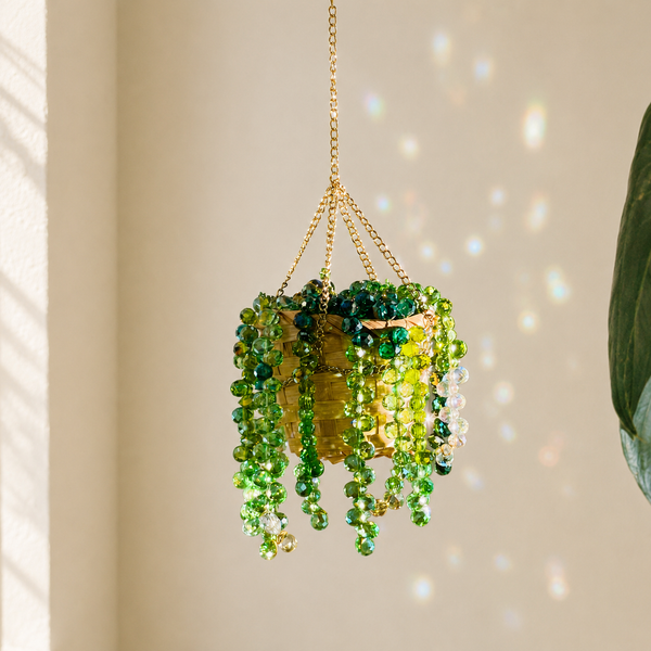 Finished handmade green beaded hanging plant with rainbow light reflections